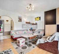 Living room in a two-room apartment with a comfortable sofa and wooden furniture.