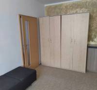 Wardrobe and benches in the room of a 3-room apartment.