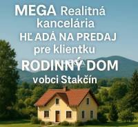 A family house in the village of Stakčín surrounded by greenery and mountain scenery.