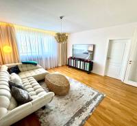 Living room in a 3-room apartment with a sofa, television, and curtains on the window.