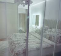 Bedroom in a 3-room apartment with a bed, wardrobe, and mirror.