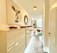 Interior of a 3-room apartment with a bright corridor, art, and furniture.