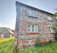 Family house in Olešná on Centrum Street with a raw brick facade and a garden.
