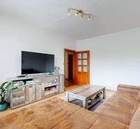 Living room in a 3-room apartment with a sofa, television, and table.