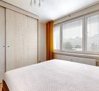 A bedroom with a large wardrobe and a window in a 3-room apartment.