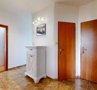Entrance hall in a 3-room apartment with wooden doors and flooring.