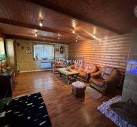 A kitchen with a wooden ceiling and floor in a family house, with dining and equipment.