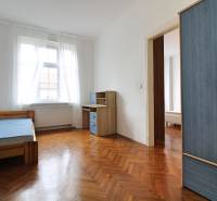 A bright room in a 3-room apartment with a stylish blue wardrobe and a desk.