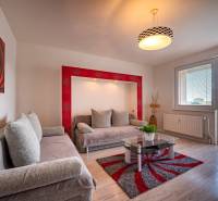 Living room in a 3-room apartment with sofas, a glass table, and a balcony.