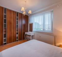 Bedroom in a 3-room apartment with a built-in wardrobe, window, and table.