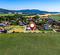 Aerial view of the village development in Nižná Kamenica, surrounded by residential land.