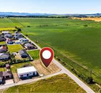 Aerial view of residential plots in Nižná Kamenica with green fields surrounding them.
