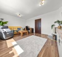 Living room with comfortable sofa seating and a television in a 3-room apartment.