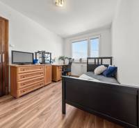 A room in a 3-room apartment with a bed, a dresser, and a desk, interior.
