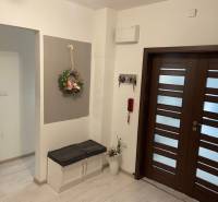 Entrance hall in a 3-room apartment with light floors and a shoe cabinet.