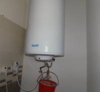 Hot water tank with installation and tiles in a family house.