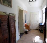 A cozy hallway with wooden doors and furniture in a family house.
