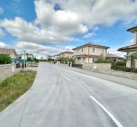 Južná Brána Street in Senec with development for plots - housing, the sky is overcast.