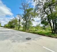 A road surrounded by trees on Južná Brána Street in Senec, suitable for residential plots.