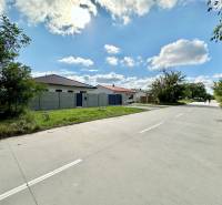 The road at the South Gate in Senec leads by family houses on the plots - residential area.