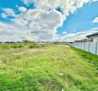 Residential plots at Južná Brána in Senec with grassy area and blue sky.