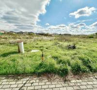 A grassy plot at Južná Brána, Senec, suitable for living, with a view of the houses.