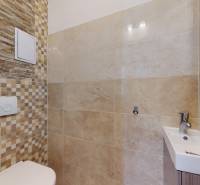 Modern tiles in the bathroom of a 4-room apartment with a sink and toilet.