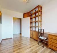 A study room in a 4-room apartment with wooden furniture and laminate flooring.
