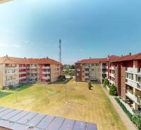 Apartment buildings on Viztorony Street in Rajka with a green courtyard and an antenna in the background.