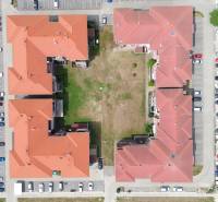Aerial view of a building with a red roof and a parking lot on Viztorony Street in Rajka.