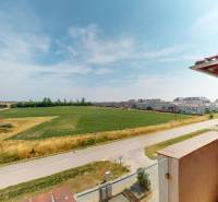 View from the balcony of a 4-room apartment on Viztorony Street in Rajka with fields and houses.