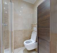 Bathroom in a 4-room apartment with a toilet and a shower.