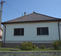 A family house in Trstín with a fence and a garden.
