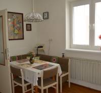 Dining room in a family house with a table, chairs, a painting, and a light fixture.