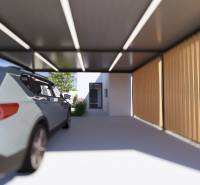 A car parked under the shelter of a family house in Gaboltov, next to wooden cladding.