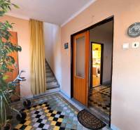 Entrance hallway with tiled floor; doors lead to the living area of a detached family house.
