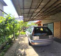 A car parked by a family house on the street in Partizánske, Malé Bielice area.
