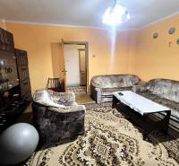 Living room in a family house with a sofa, carpet, and cabinet set.