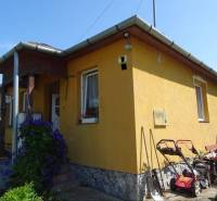 A family house on Futrinka Street in Krasznokvajda, with shrubs and floral decorations.