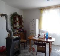 A kitchen in a family house with a stove, table, refrigerator, and furniture for decorations.