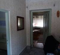 Hallway in a family house with access to the bathroom and living room.