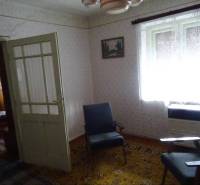 Interior of a family house with retro furniture, carpet, and chairs.