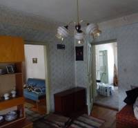 Living room in a family house with antique furniture and a hanging chandelier.