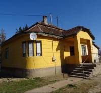 Yellow family house in Vilmany with a terrace and a satellite dish.