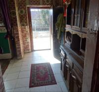 A hallway with carpet and wooden furniture in a family house.