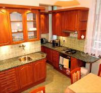 Wooden kitchen in hotels and guesthouses with a dining table and appliances.