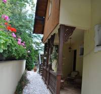 Pathway with flowers and a bench near the guesthouse in Košice - Sever, in the area of Hotels and Guesthouses.