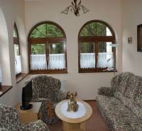 A room in hotels and guesthouses with patterned furniture and arched windows.
