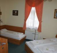 A room with two beds, curtains, paintings, interior of hotels and guesthouses.