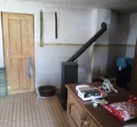 The interior of a family house with tiles, wooden doors, and patterned flooring.
